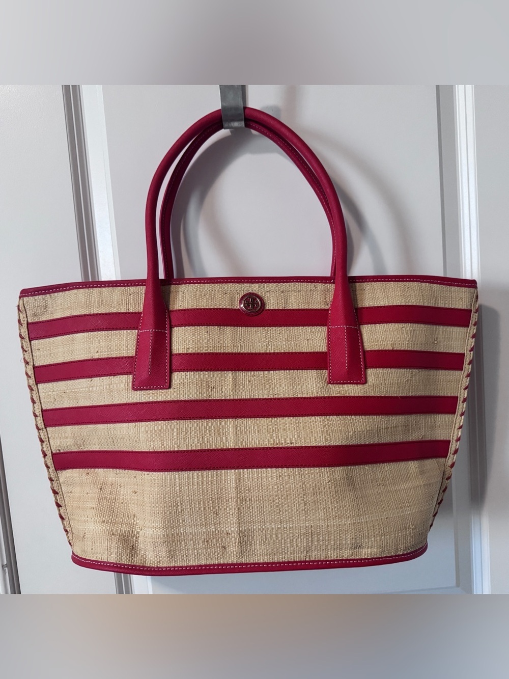 Tory Burch straw tote features vibrant red leather stripes